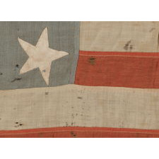13 STARS IN A 4-5-4 PATTERN, ON A FLAG OF THE CIVIL WAR ERA, WITH BEAUTIFUL COLORATION AND IN A TINY SCALE AMONGST ITS PIECED-AND-SEWN COUNTERPARTS