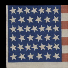 39 CANTED STARS ON AN ANTIQUE AMERICAN FLAG DATING TO THE 1876 CENTENNIAL, NEVER AN OFFICIAL STAR COUNT, REFLECTS THE ANTICIPATED ARRIVAL OF THE DAKOTA TERRITORY