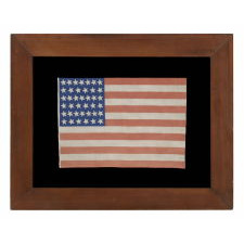 39 CANTED STARS ON AN ANTIQUE AMERICAN FLAG DATING TO THE 1876 CENTENNIAL, NEVER AN OFFICIAL STAR COUNT, REFLECTS THE ANTICIPATED ARRIVAL OF THE DAKOTA TERRITORY