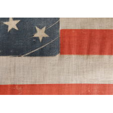 38 STAR ANTIQUE AMERICAN FLAG WITH A TRIPLE-WREATH STYLE MEDALLION CONFIGURATION AND 2 OUTLIERS, ON A LARGE SCALE PARADE FLAG, 1876-1889, COLORADO STATEHOOD