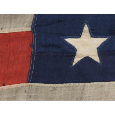 35 SINGLE-APPLIQUÉD STARS ON A CIVIL WAR PERIOD FLAG, SIGNED BY A SURGEON FROM SARATOGA SPRINGS, NEW YORK WHO SERVED WITH THE 29TH NEW YORK STATE MILITIA, WHICH MUSTERED OUT ON JUNE 20TH, 1863, THE EXACT DAY UPON WHICH WEST VIRGINIA BECAME THE 35TH STATE; OFFICIAL FROM THAT YEAR UNTIL 1865