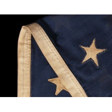 39 STARS ON AN ANTIQUE AMERICAN FLAG WITH HAND-SEWN, SINGLE-APPLIQUÉD STARS, MADE BY ANNIN IN NEW YORK CITY, DATING TO THE 1876 CENTENNIAL OF AMERICAN INDEPENDENCE, NEVER AN OFFICIAL STAR COUNT, REFLECTS THE ANTICIPATED ARRIVAL OF COLORADO AND THE DAKOTA TERRITORY