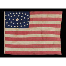 34 STARS IN AN OUTSTANDING OVAL MEDALLION CONFIGURATION, ON A NARROW CANTON THAT RESTS ON THE 6TH STRIPE, A HOMEMADE, ANTIQUE AMERICAN FLAG OF THE CIVIL WAR PERIOD, ENTIRELY HAND-SEWN, 1861-63, KANSAS STATEHOOD