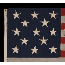 13 STARS ARRANGED IN A 3-2-3-2-3 PATTERN ON A SMALL-SCALE ANTIQUE AMERICAN FLAG MARKED "UNITED STATES ARMY STANDARD BUNTING", CA 1895 - 1910