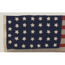 34 STARS ON A HOMEMADE AND ENTIRELY HAND-SEWN FLAG OF THE CIVIL WAR PERIOD, THE SMALLEST I HAVE EVER ENCOUNTERED AMONG PIECED-AND-SEWN WOOL EXAMPLES, AN EXTRAORDINARY FIND, 1861-63, KANSAS STATEHOOD