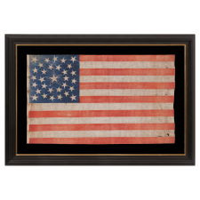 31 STARS ON AN ANTIQUE AMERICAN FLAG WITH ITS STARS CONFIGURED IN A MEDALLION PATTERN THAT FEATURES A LARGE, HALOED CENTER STAR; REFLECTS THE PERIOD WHEN CALIFORNIA HAD RECENTLY BECOME THE 31ST STATE TO ENTER THE UNION, 1850-1858