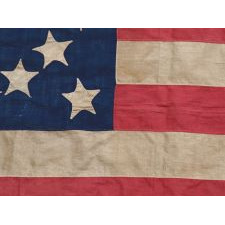34 STARS ARRANGED IN A BEAUTIFUL RENDITION OF THE MEDALLION CONFIGURATION WITH OFFSET WREATHS AND A LARGE CENTER STAR, MADE DURING THE OPENING YEARS OF THE CIVIL WAR, 1861-1863, AND ENTIRELY HAND-SEWN, REFLECTS KANSAS STATEHOOD