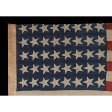 40 CANTED STARS IN AN ORDERLY PHALANX, ON AN ANTIQUE AMERICAN FLAG WITH A RARE STAR COUNT, ACCURATE FOR JUST SIX DAYS AND NEVER OFFICIAL, REFLECTING SOUTH DAKOTA’S ADMISSION TO THE UNION