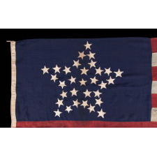 SPECTACULAR ANTIQUE AMERICAN FLAG WITH 31 STARS ARRANGED IN THE "GREAT STAR" PATTERN; ITS CANTON RESTING THE WAR STRIPE, 1850- 1858, CALIFORNIA STATEHOOD