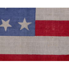 34 STARS ON AN ANTIQUE AMERICAN FLAG, PRINTED ON SILK, WITH "DANCING" OR "TUMBLING" ORIENTATION, CIVIL WAR PERIOD, 1861-1863, REFLECTS THE ADDITION OF KANSAS TO THE UNION AS A FREE STATE