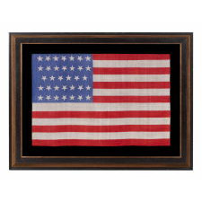 34 STARS ON AN ANTIQUE AMERICAN FLAG, PRINTED ON SILK, WITH "DANCING" OR "TUMBLING" ORIENTATION, CIVIL WAR PERIOD, 1861-1863, REFLECTS THE ADDITION OF KANSAS TO THE UNION AS A FREE STATE