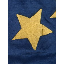 34 GILT PAINTED STARS IN A BOLD REPRESENTATION OF THE “GREAT STAR” PATTERN, ON A SILK, ANTIQUE AMERICAN FLAG MADE DURING THE OPENING YEARS OF THE CIVIL WAR, 1861-63, PROBABLY MADE UNDER MILITARY CONTRACT OR FOR USE BY LOCAL MILITIA, ENTIRELY HAND-SEWN, IN A TINY SCALE FOR THE PERIOD