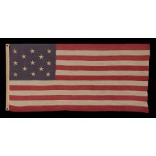 13 STARS IN A 3-2-3-2-3 PATTERN ON A DUSTY BLUE CANTON, ON A SMALL-SCALE, ANTIQUE AMERICAN FLAG WITH AN ELONGATED PROFILE, MADE DURING THE LAST DECADE OF THE 19TH CENTURY, CA 1890-1895