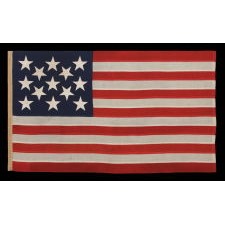 13 STAR ANTIQUE AMERICAN FLAG, A U.S. NAVY SMALL BOAT ENSIGN WITH ENORMOUS HAND-SEWN STARS, IN A REMARKABLE STATE OF PRESERVATION, MADE CA 1890-1899
