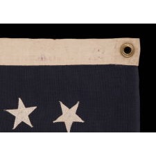 13 STARS IN AN OVAL VERSION OF THE 3RD MARYLAND PATTERN, ON A SMALL SCALE, ANTIQUE AMERICAN FLAG MADE BETWEEN APPROXIMATELY 1926 AND THE WWII ERA