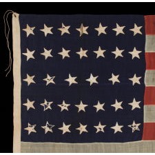 34 STARS ON AN ANTIQUE AMERICAN FLAG MADE DURING THE OPENING YEARS OF THE CIVIL WAR, WITH SPLENDID PRESENTATION RESULTING FROM THE ENDEARING CHARACTERISTICS OF LONG-TERM USE, POSSIBLY FIELD-CARRIED BY A UNION REGIMENT, CA 1861-63, KANSAS STATEHOOD