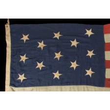 U.S. NAVY SMALL BOAT ENSIGN WITH 13 HAND-SEWN STARS, PROBABLY MADE BETWEEN MADE BETWEEN 1866 AND 1870, IN THE LARGEST SIZE DICTATED BY NAVY REGULATIONS, A VERY SCARCE AND BEAUTIFUL EXAMPLE WITH A 3-2-3-2-3 CONFIGURATION OF LINEAL ROWS