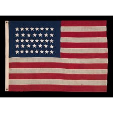 38 HAND-SEWN STARS IN AN UNUSUALLY CONFINED PATTERN OF JUSTIFIED ROWS, ON AN ANTIQUE FLAG IN AN ESPECIALLY SMALL SCALE FOR THE PERIOD, 1876-1889, COLORADO STATEHOOD