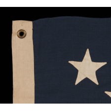 13 STAR ANTIQUE AMERICAN FLAG WITH A BEAUTIFUL MEDALLION CONFIGURATION, A SMALL SCALE EXAMPLE OF THE 1876 CENTENNIAL ERA