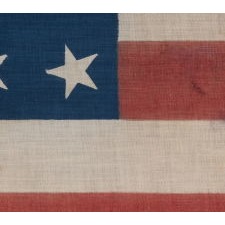 39 STARS WITH BOTH DANCING AND CANTED POSITIONING, ALTERNATING FROM ROW-TO-ROW, ON AN ANTIQUE AMERICAN FLAG LIKELY MADE FOR THE 1876 CENTENNIAL, NEVER AN OFFICIAL STAR COUNT, REFLECTS THE ANTICIPATED ARRIVAL OF THE DAKOTA TERRITORY