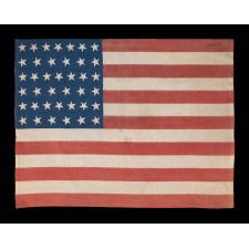 39 STARS WITH BOTH DANCING AND CANTED POSITIONING, ALTERNATING FROM ROW-TO-ROW, ON AN ANTIQUE AMERICAN FLAG LIKELY MADE FOR THE 1876 CENTENNIAL, NEVER AN OFFICIAL STAR COUNT, REFLECTS THE ANTICIPATED ARRIVAL OF THE DAKOTA TERRITORY