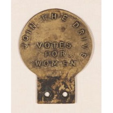 ANTIQUE BRASS SUFFRAGETTE CAR BADGE WITH TEXT THAT READS: "JOIN THE DRIVE" AND "VOTES FOR WOMEN," BRITISH, CA 1905-1914