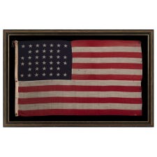 38 STARS IN A NOTCHED, CROSSHATCH PATTERN ON AN ANTIQUE AMERICAN FLAG MADE BY THE U.S. BUNTING COMPANY IN LOWELL, MASSACHUSETTS, SIGNED "TORREY," REFLECTS THE ERA OF COLORADO STATEHOOD, CIRCA 1876-1889