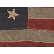 13 STAR FLAG WITH HAND-SEWN, CANTED STARS IN A 3-2-3-2-3 PATTERN, THE ONLY EXAMPLE I HAVE EVER ENCOUNTERED WITH THE MARK OF THE “UNITED STATES LIGHTHOUSE ESTABLISHMENT”, AN EXCEPTIONAL EXAMPLE IN A WONDERFUL SMALL SCALE, MADE ca 1880 - 1895