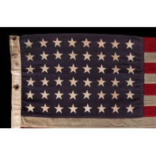 WWII VINTAGE ANTIQUE AMERICAN FLAG WITH 48 STARS AND ENDEARING WEAR FROM OBVIOUS LONG-TERM USE, A U.S. NAVY SMALL BOAT ENSIGN, MARKED "No. 11, DATED “1943,” MADE AT MARE ISLAND, CALIFORNIA, HEADQUARTERS OF THE PACIFIC FLEET