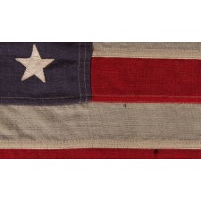 WWII VINTAGE ANTIQUE AMERICAN FLAG WITH 48 STARS AND ENDEARING WEAR FROM OBVIOUS LONG-TERM USE, A U.S. NAVY SMALL BOAT ENSIGN, MARKED "No. 11, DATED “1943,” MADE AT MARE ISLAND, CALIFORNIA, HEADQUARTERS OF THE PACIFIC FLEET