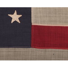 44 STAR FLAG WITH BEAUTIFULLY HAND-SEWN STARS IN AN HOURGLASS PATTERN ON A SOLDIER BLUE CANTON, AN ANTIQUE EXAMPLE; REFLECTS THE ADDITION OF WYOMING 1890-1896