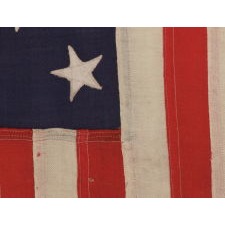 13 STARS IN A 3-2-3-2-3 PATTERN ON A UNITED STATES NAVY SMALL BOAT ENSIGN OF EXCEPTIONALLY SMALL SCALE, MADE AT THE BROOKLYN NAVY YARD, NEW YORK, SIGNED & DATED 1906