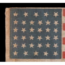 34 STARS, WITH SCATTERED POSITIONING, ON AN ANTIQUE AMERICAN PARADE FLAG MADE DURING THE OPENING TWO YEARS OF THE CIVIL WAR, 1861-63, KANSAS STATEHOOD