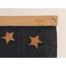 ONE OF THE EARLIEST 13 STAR ANTIQUE AMERICAN FLAGS THAT ONE WILL EVER ENCOUNTER, CIRCA 1820's-1840's, ENTIRELY HAND-SEWN, WITH SINGLE-APPLIQUÉD STARS IN A 4-5-4 ARRANGEMENT, TINY IN SCALE AMONG ITS COUNTERPARTS