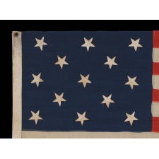 13 STARS IN A 3-2-3-2-3 LINEAL CONFIGURATION ON AN ANTIQUE AMERICAN FLAG MADE IN NEW YORK CITY BY JOHN BOYLE & COMPANY, CA 1885-1900, WITH AN UNUSUAL, BLACK-INKED STENCIL ALONG THE HOIST THAT READS “BOYLE’S YACHT SAIL”