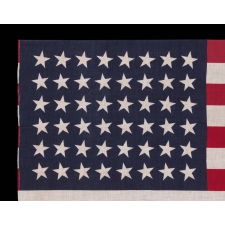 48 STAR STAR FLAG WITH STARS CANTED TO THE RIGHT AND LEFT IN DANCING ROWS, A RARE VARIETY OF ANTIQUE AMERICAN PARADE FLAG IN A LARGE SCALE, 1912-1918 OR PERHAPS EARLIER, ARIZONA & NEW MEXICO STATEHOOD