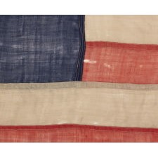 13 STAR FLAG OF THE CIVIL WAR PERIOD (1861-1865), WITH A CIRCULAR VERSION OF WHAT IS KNOWN AS THE 3RD MARYLAND PATTERN AND WITH EXCEPTIONALLY ENDEARING GRAPHIC QUALITIES FROM HAVING BEEN EXTENSIVELY FLOWN, PERHAPS AS A BATTLE FLAG OR TO MARK A SITE IN THE RECRUITMENT OF SOLDIERS