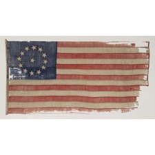 13 STAR FLAG OF THE CIVIL WAR PERIOD (1861-1865), WITH A CIRCULAR VERSION OF WHAT IS KNOWN AS THE 3RD MARYLAND PATTERN AND WITH EXCEPTIONALLY ENDEARING GRAPHIC QUALITIES FROM HAVING BEEN EXTENSIVELY FLOWN, PERHAPS AS A BATTLE FLAG OR TO MARK A SITE IN THE RECRUITMENT OF SOLDIERS