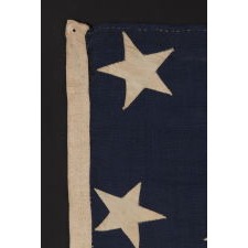 ENTIRELY HAND-SEWN, U.S. NAVY SMALL BOAT ENSIGN OF THE CIVIL WAR PERIOD, WITH 13 STARS IN A 4-5-4 CONFIGURATION, IN THE SMALLEST REGULATION SIZE RECORDED BY THE NAVY DURING THIS GENERAL ERA