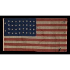 34 STARS IN 4 ROWS WITH 2 STARS OFFSET AT THE HOIST END, LIKELY A UNION ARMY CAMP COLORS, ONE OF ONLY THREE EXAMPLES I HAVE ENCOUNTERED IN THIS EXACT STYLE, OPENING TWO YEARS OF THE CIVIL WAR, 1861-1863, REFLECTS THE PERIOD WHEN KANSAS WAS THE MOST RECENT STATE TO JOIN THE UNION