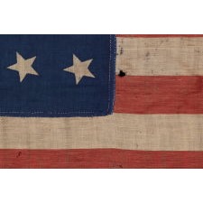 34 STARS IN 4 ROWS WITH 2 STARS OFFSET AT THE HOIST END, LIKELY A UNION ARMY CAMP COLORS, ONE OF ONLY THREE EXAMPLES I HAVE ENCOUNTERED IN THIS EXACT STYLE, OPENING TWO YEARS OF THE CIVIL WAR, 1861-1863, REFLECTS THE PERIOD WHEN KANSAS WAS THE MOST RECENT STATE TO JOIN THE UNION