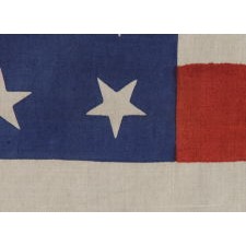 37 STARS ON A LARGE SCALE SILK PARADE FLAG WITH HAND-INSCRIBED MOURNING NOTATION REGARDING THE 1880 DEATH OF PRESIDENT JAMES GARFIELD AND ITS STARS ARRANGED IN A "DANCING" OR "TUMBLING" ORIENTATION, NEBRASKA STATEHOOD, 1867-1876, THE ERA OF AMERICAN RECONSTRUCTION