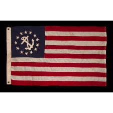 ANTIQUE AMERICAN PRIVATE YACHT FLAG (ENSIGN) WITH 13 STARS SURROUNDING A CANTED ANCHOR, AN ATTRACTIVE, ELONGATED EXAMPLE WITH AN OFF-SET DEVICE, CIRCA 1905 – 1920