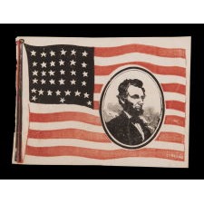 EXTREMELY RARE ABRAHAM LINCOLN MOURNING FLAG, WITH HIS PORTRAIT IN THE STRIPED FIELD; PRINTED ON PAPER, SIGNED “LYBRAND,” 1865