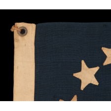 13 HAND-SEWN STARS IN A CIRCULAR VERSION OF THE 3RD MARYLAND PATTERN, MADE DURING THE CIVIL WAR PERIOD OR IMMEDIATELY THEREAFTER, IN A GREAT SMALL SCALE AMONG ITS COUNTERPARTS OF THE PERIOD WITH PIECED-AND-SEWN CONSTRUCTION