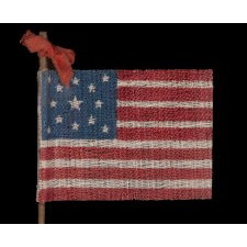 13 STAR ANTIQUE AMERICAN PARADE FLAG WITH A MEDALLION STAR CONFIGURATION, MADE FOR THE 1876 CENTENNIAL CELEBRATION