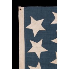 ANTIQUE CIVIL WAR FLAG WITH 34 LARGE STARS, ORIENTED IN ALL DIRECTIONS, ON A RICH, STEEL BLUE CANTON, REFLECTS KANSAS STATEHOOD, 1861-63