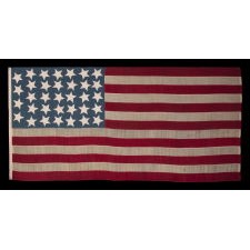 ANTIQUE CIVIL WAR FLAG WITH 34 LARGE STARS, ORIENTED IN ALL DIRECTIONS, ON A RICH, STEEL BLUE CANTON, REFLECTS KANSAS STATEHOOD, 1861-63