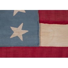 20 STARS AND 11 STRIPES ON AN ANTIQUE AMERICAN FLAG OF THE CIVIL WAR PERIOD, HOMEMADE AND ENTIRELY-HAND-SEWN, WITH ITS LIGHT BLUE CANTON RESTING ON THE WAR STRIPE; PROBABLY MADE TO COMMEMORATE THE DECEMBER 10TH, 1817 ADDITION OF MISSISSIPPI AS THE 20TH STATE, AND THE COUNT OF 11 STATES THAT SECEDED FROM THE UNION BETWEEN DECEMBER OF 1860 AND JUNE OF 1861