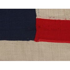 13 STAR FLAG WITH AN ELLIPTICAL MEDALLION OF HAND-SEWN STARS THAT FEATURES A ROW OF THREE IN THE CENTER, A DESIGN IDENTIFIED ON JUST FOUR SURVIVING ANTIQUE FLAGS; CIVIL WAR - CENTENNIAL ERA (1861-1876)
